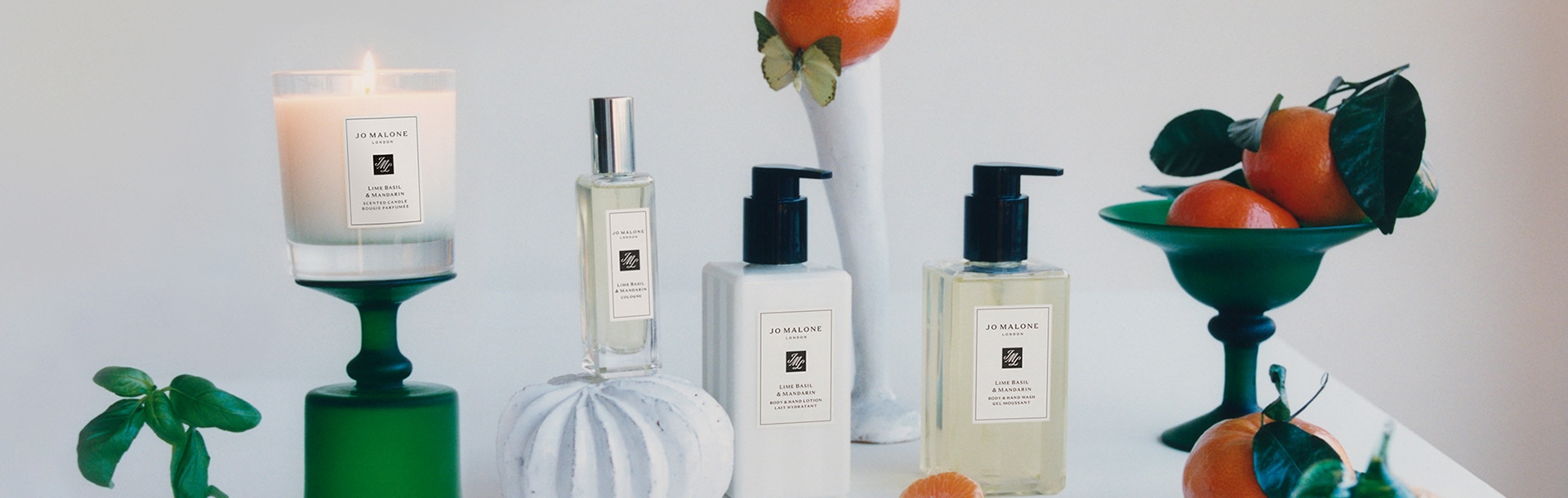 image of Jo Malone London body and hand wash, lotion and cologne in sizes under $50 with 8 globes in the background